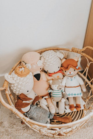 Rattan basket filled with stuffed baby toys