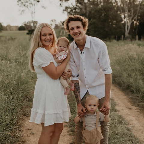 Image of happy family of four, a mum, a dad, and two kids under 2