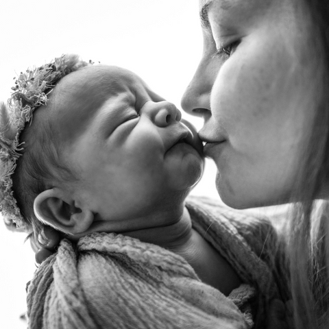 image of mother kissing baby
