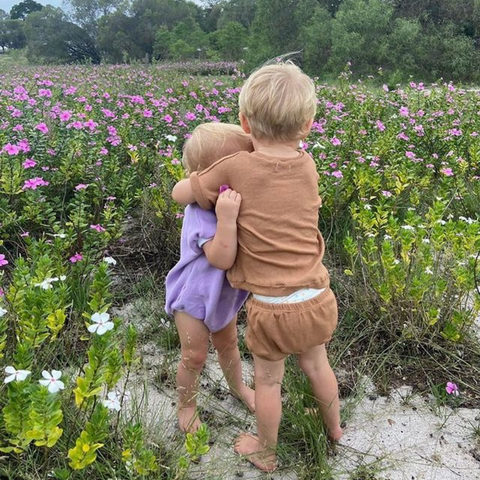 Image of baby brother hugging little sister