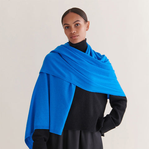 a model wearing a blue cashmere wrap around them like a scarf
