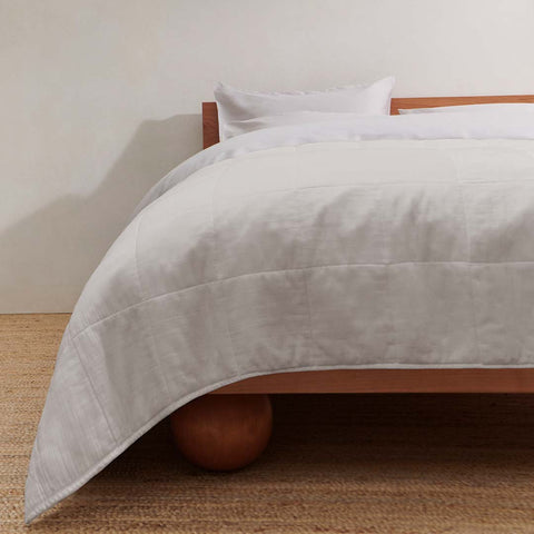 image of white bedding on a wooden bed frame