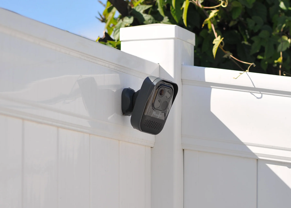 the Toucan Wireless Security Camera PRO installed outside a property with a tree in the background