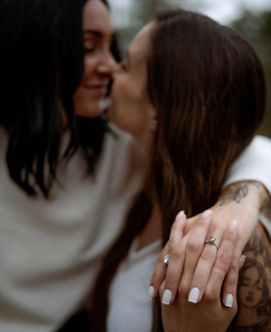 Two Women Kissing After Getting Engaged with Salt & Pepper Hexagon Ring