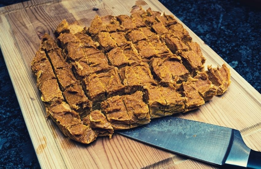 Homemade dog treats made of pumpkin arranged on wooden board