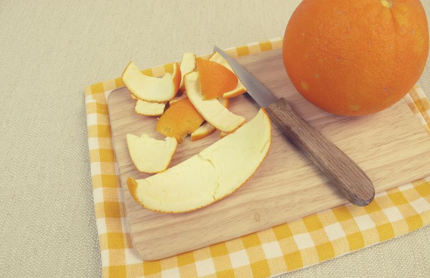 Orange peels on wooden chopping board