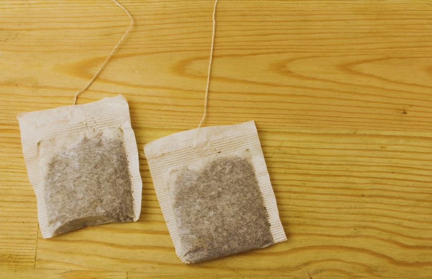 two tea bags on wooden desk