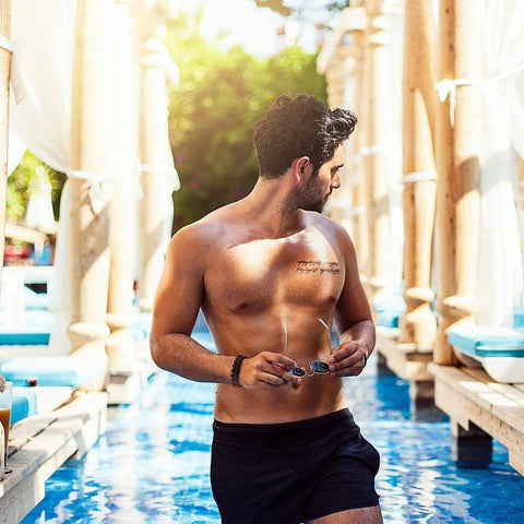 man with natural looking tan in pool