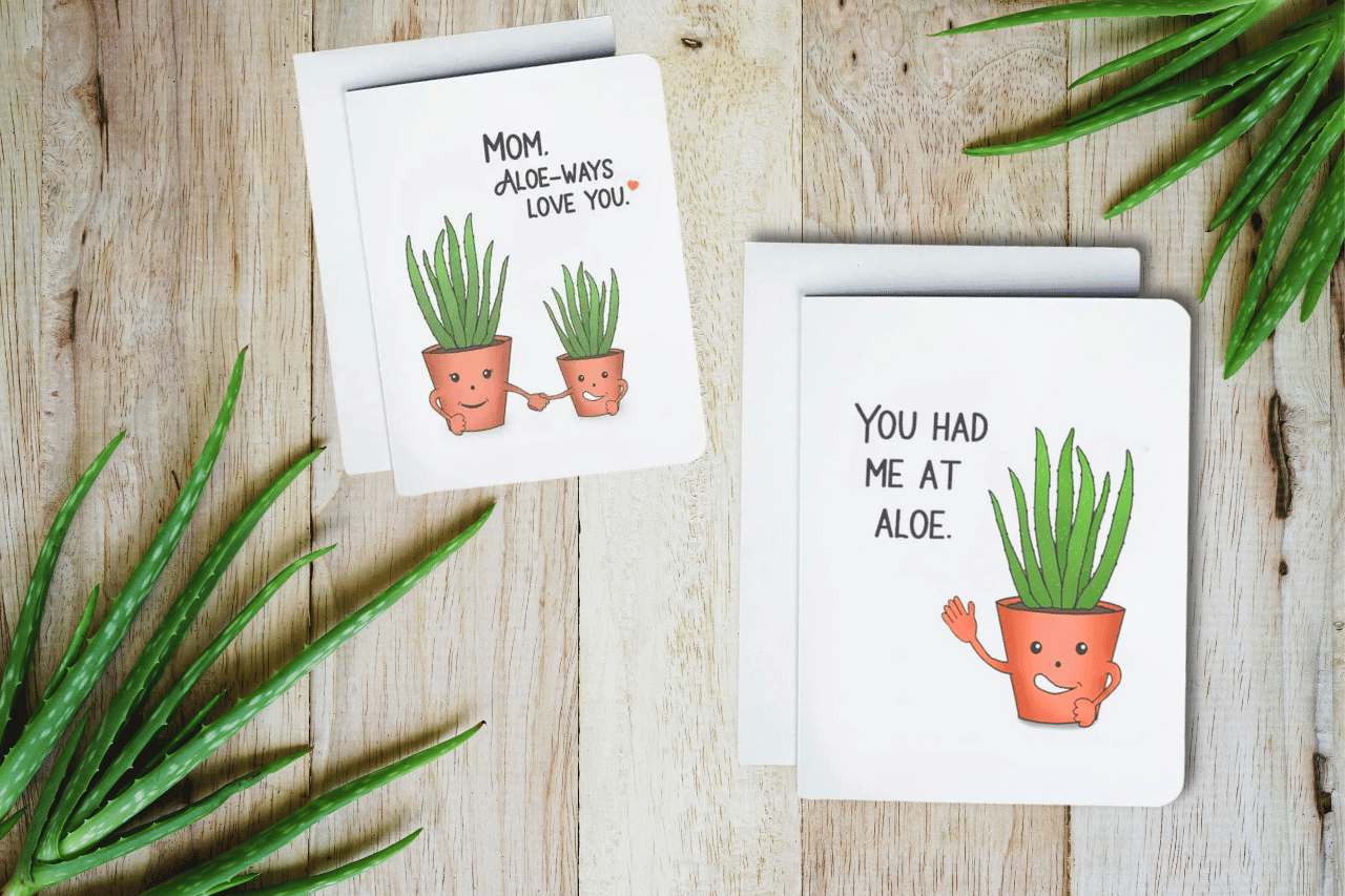 A photo of two cards. They have Aloe Plants on them. they're waving and smiling. Text reads, You Had Me At Aloe.