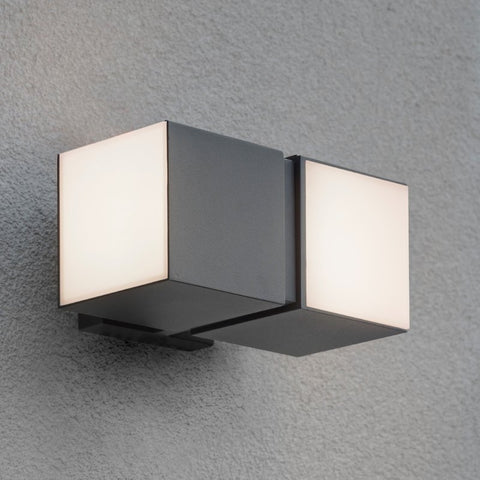A cube outdoor wall light mounted on an outdoor wall.