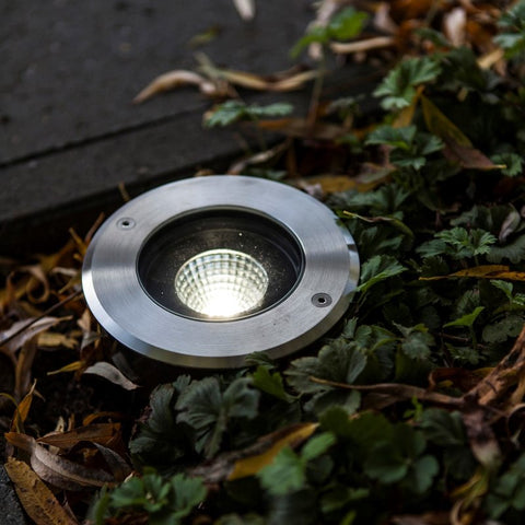 A recessed ground light on a patio.