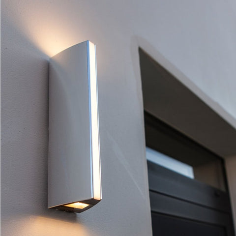 An outdoor wall light mounted near a garage door.