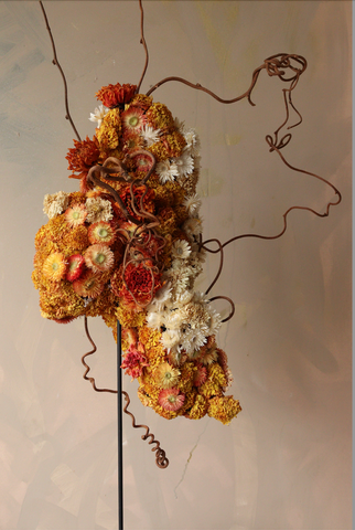 Orange and white dried flowers in a sculptural arrangements