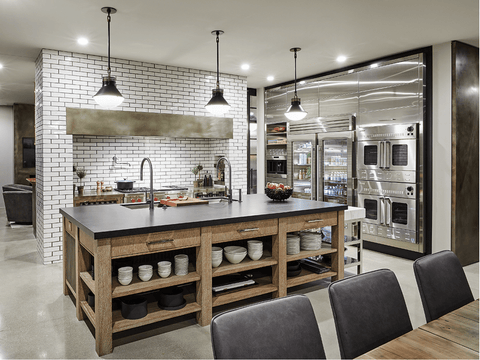 Modern restaurant kitchen with fridges and cooking island