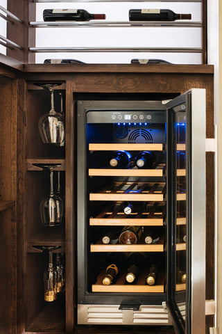 The wine fridge's minimalist design and stainless steel finish blend seamlessly with the sophisticated decor, enhancing the overall ambiance of the space