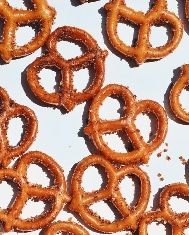 image of pretzel twists on white background with cinnamon sugar baked on top