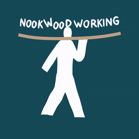 A gif of a man walking while holding a piece of lumber. The words, NookWoodworking bounce on the wood as he takes a step