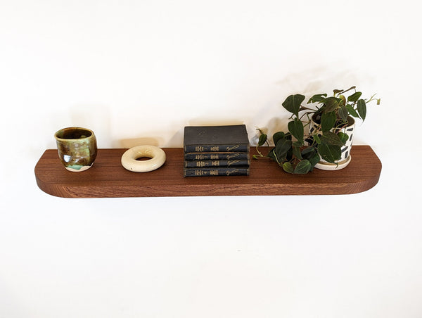 A successfully installed floating shelf in mahogany