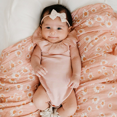 baby girl in pink bodysuit