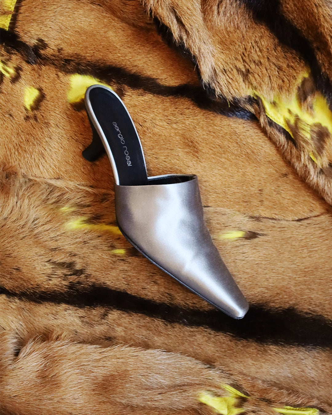 Iconic vintage heels photographed on soft fabric, highlighting the cultural significance, authenticity and timeless appeal of retro shoes.