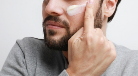 Man putting cream on face