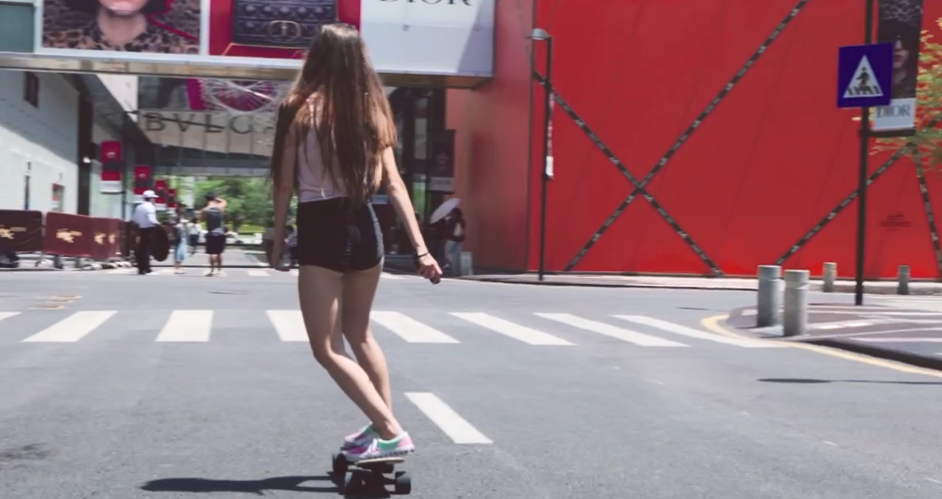 A girl riding on Jking electric skateboard