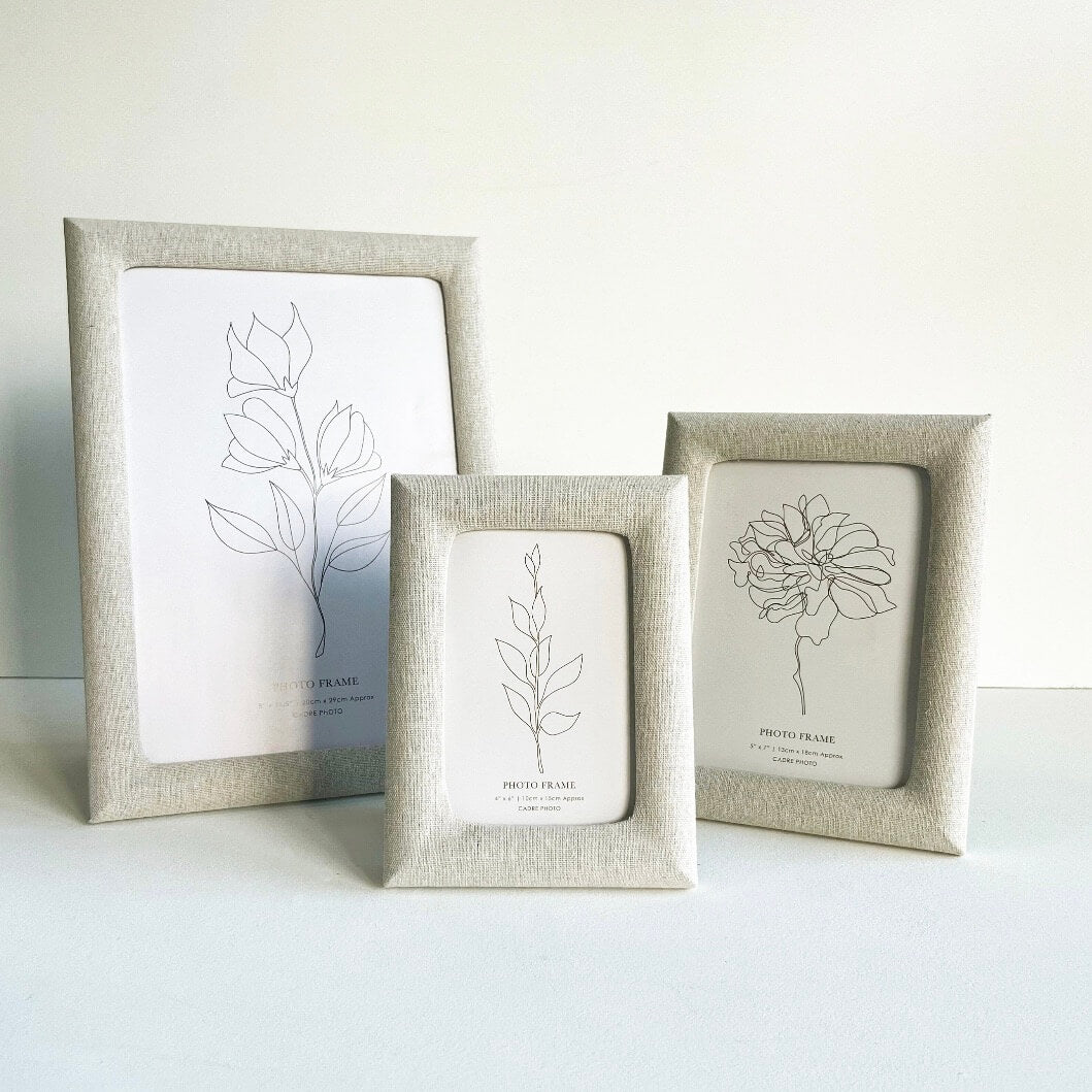 A collection of 3 linen photo frames