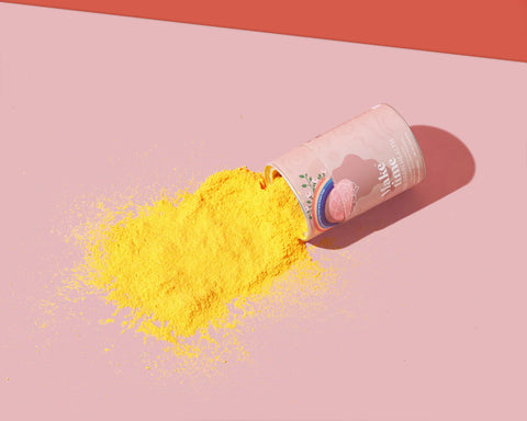 Make Time for Brain Health powder supplement spilled on canvas so orange powder is visible
