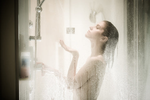 woman taking a shower in a cubicle full of steam