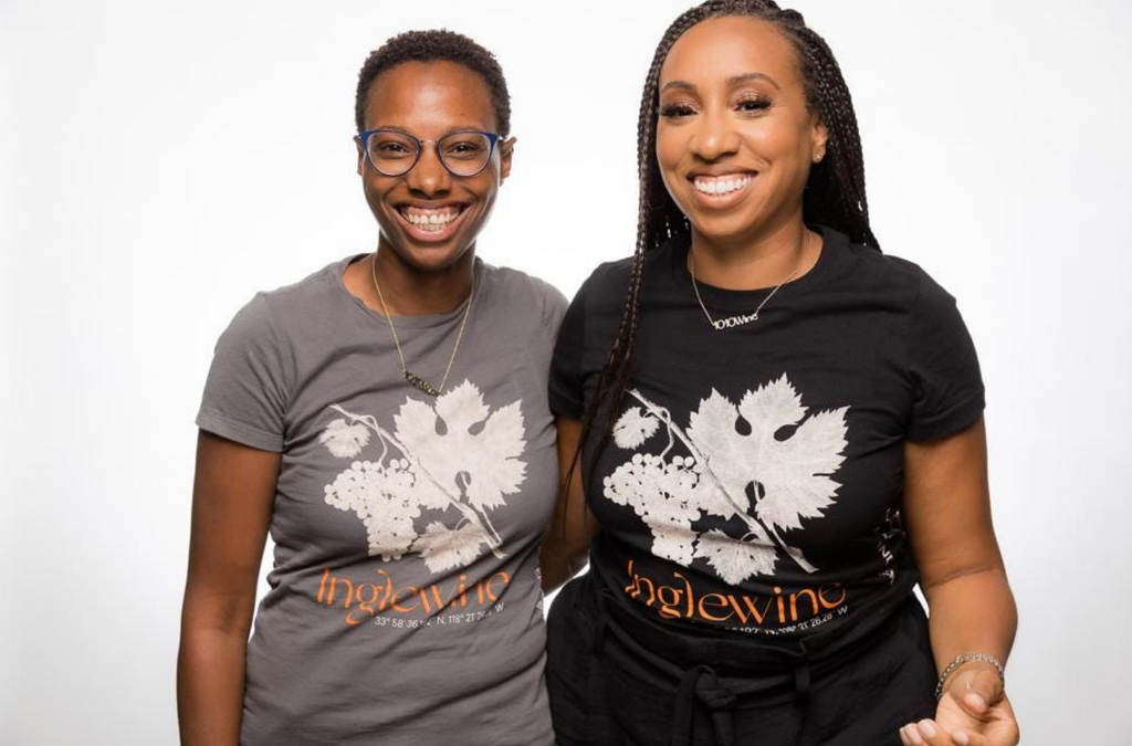 two women wearing printed tees in a studio setting