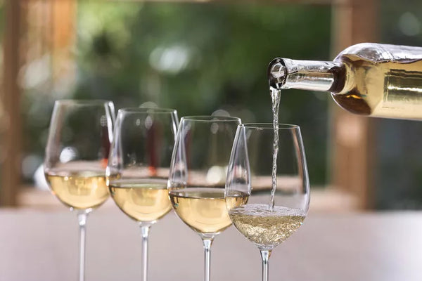 travel and leisure flight of white wine in glasses