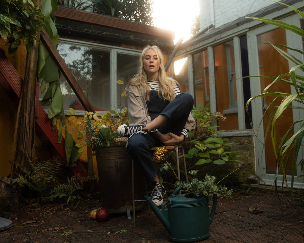 Lexy navy dungarees in courtyard