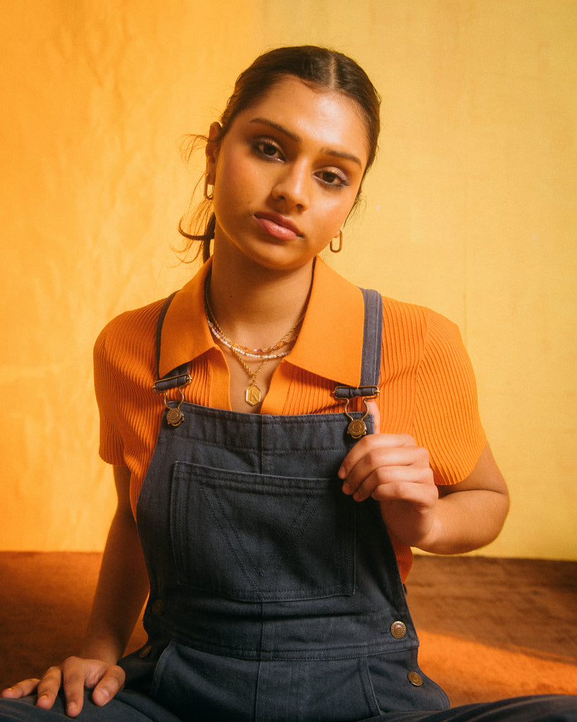 Navy blue dungaree festival outfit with orange top