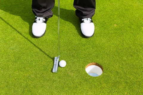 The club-behind-the-hole putting drill