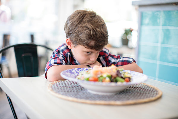 Picky child at the dinner table