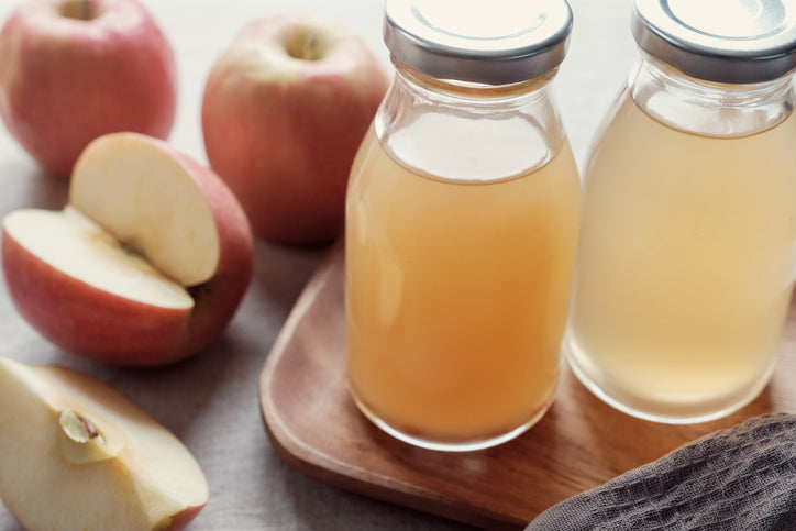 Apple cider vinegar with mother in glass bottles, probiotics food for gut health