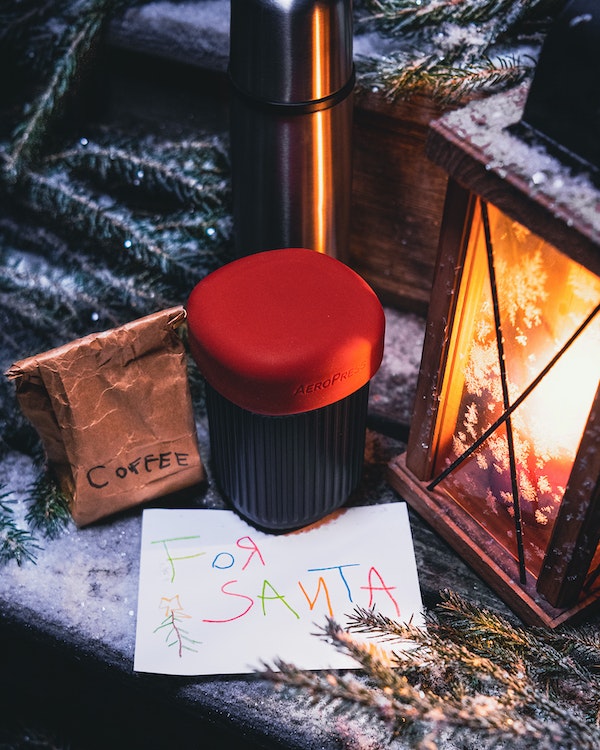 AeroPress Go mug next to letter to Santa and holiday lantern