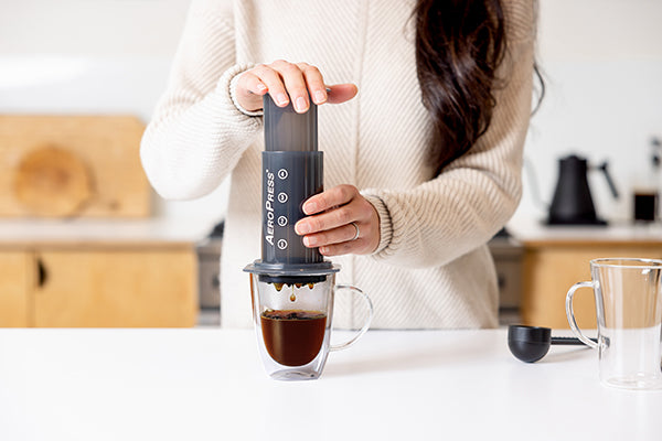 Woman brewing coffee