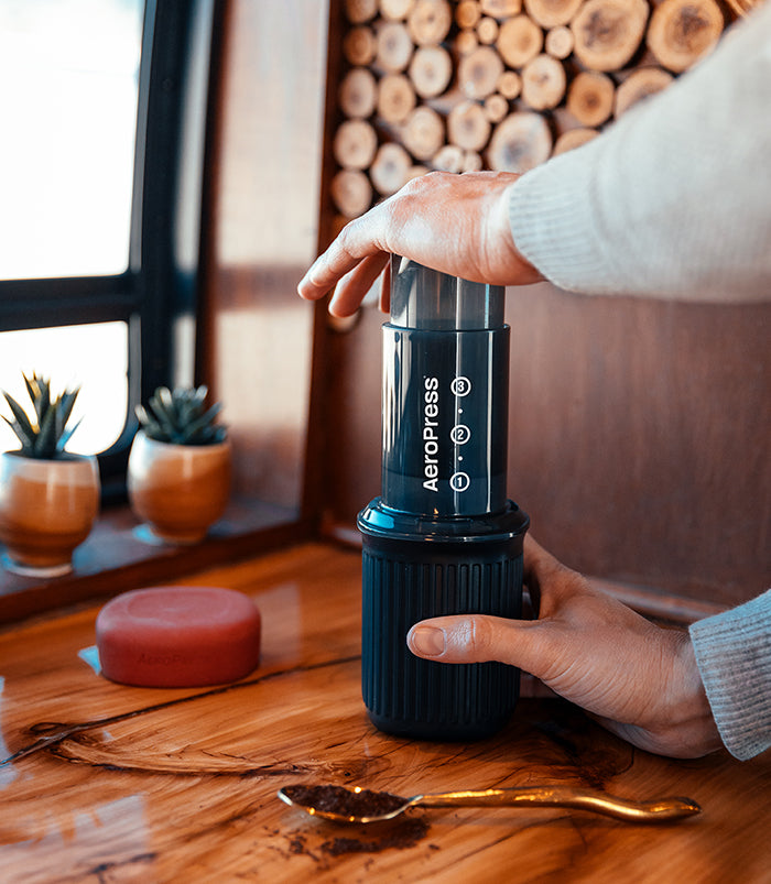 Brewing with AeroPress Go travel coffee maker in a van