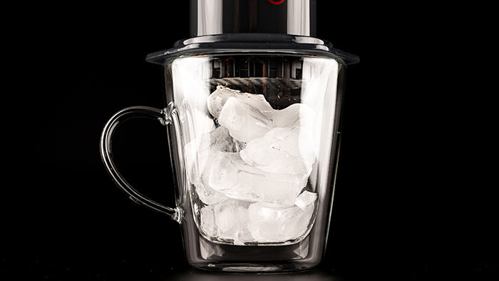 Glass mug of ice with AeroPress Original on top