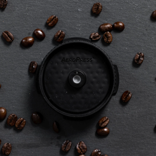 AeroPress Flow Control Filter Cap with coffee beans