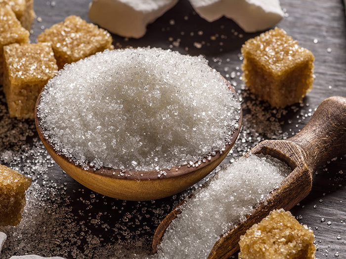 White sugar and brown sugar on a tabletop