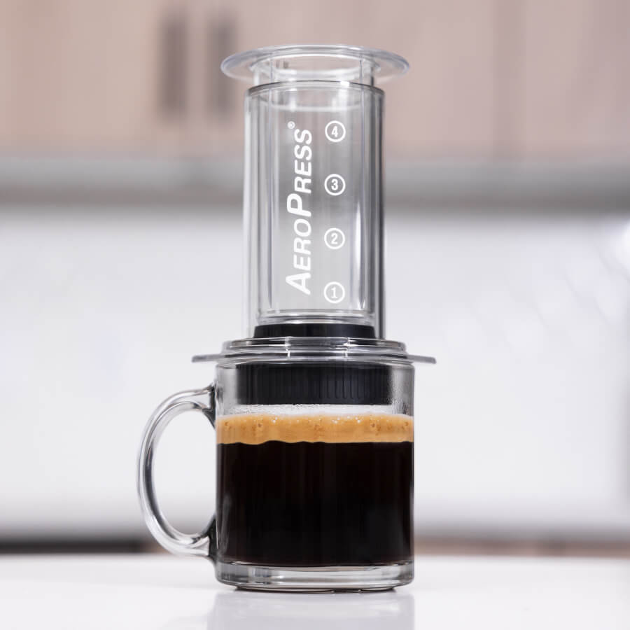 AeroPress Clear coffee maker on top of coffee with crema