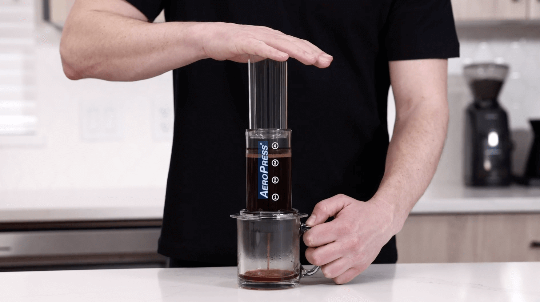 Man making espresso with an AeroPress coffee maker and Flow Control Filter Cap