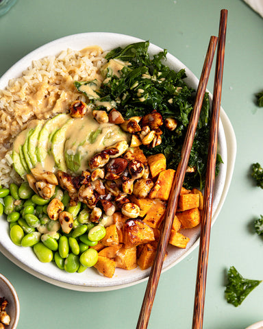 Superfood ingredients piled high & topped with tamari nuts & tahini dressing