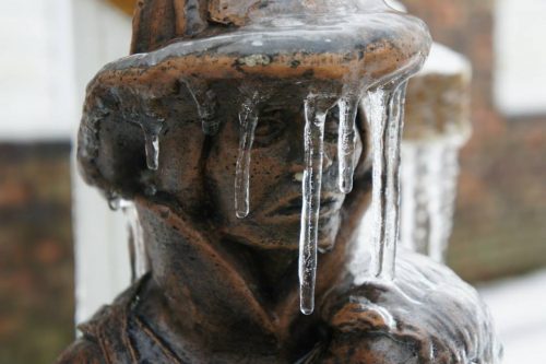 Garden statue covered with ice