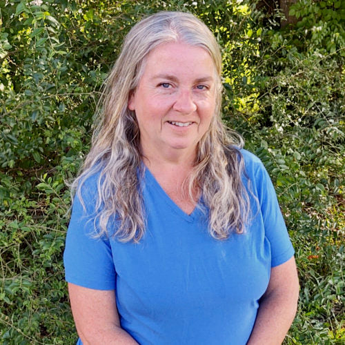 Cathy, A customer service phone peep at My Pet Chicken wears a blue shirt and smiles at the camera. 