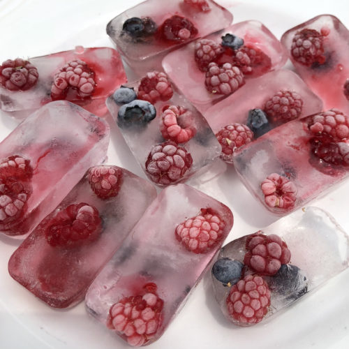 Treats for chickens. Raspberries and blueberries frozen into ice cubes.