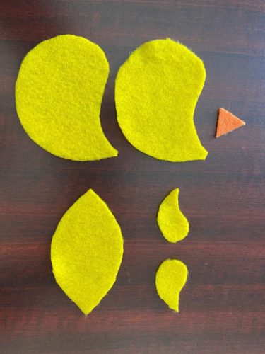 DIY chick craft pattern pieces cut out from felt and ready for assembly