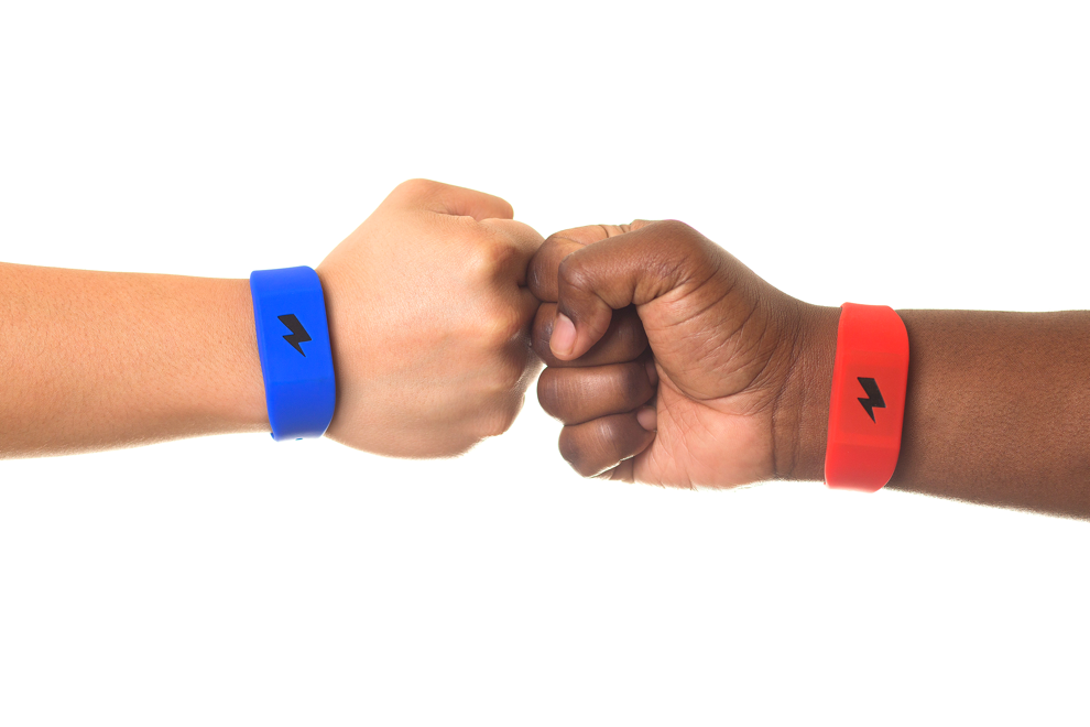 Fist bump wearing pavlok red and blue band. 